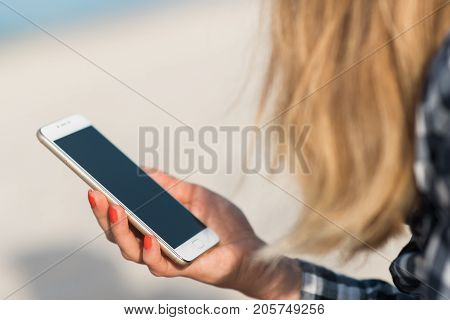 Beautiful girl holding a smartphone in the hands of a green screen green screen, hand of man holding mobile smart phone with chroma key green screen on white background, new technology concept