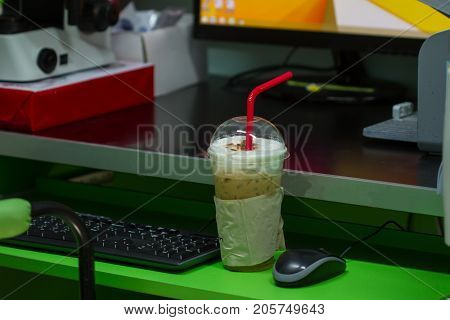 Iced Coffee On Table In Office Background