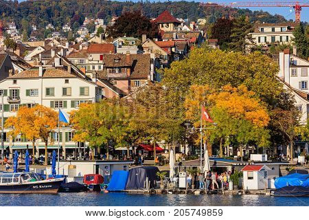 Zurich, Switzerland - 25 September, 2017: embankment of the Limmat river in the city of Zurich in the evening, old town buildings in the background. Zurich is the largest city in Switzerland and the capital of the Swiss canton of Zurich.