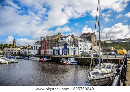 DOUGLAS, ISLE OF MAN - OCTOBER 17: Yacht docking at bay in a nice small port in a clear blue sky day in a small town of Douglas, Isle of Man