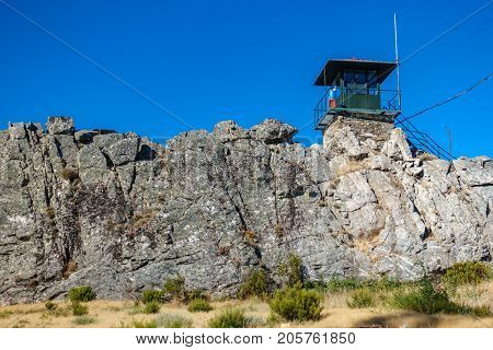 Wide angle view of fire watching hut over big rocks