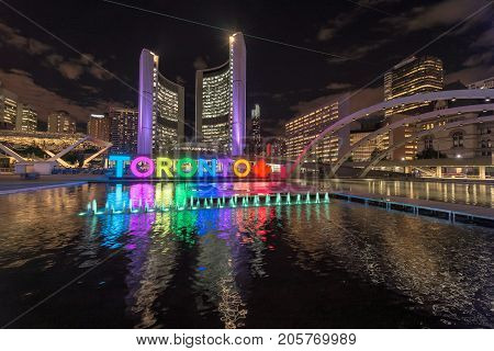 Toronto City Hall and Toronto Sign in downtown at night, in Toronto, Ontario, Canada