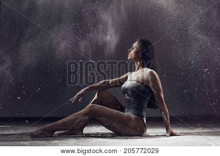 Dancer Performing Over Black Background With Powder Burst To Show Power And Movement. Dancer Perform