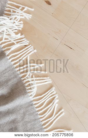 warm wool throw plaid on wooden background
