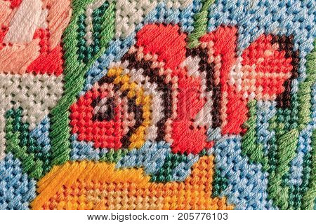 Needlepoint of various tropical fish using a variety of stitches.