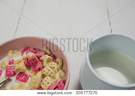 Overhead of honeycomb cereal and milk on wooden table
