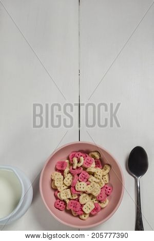 Overhead of honeycomb cereal and milk on wooden table