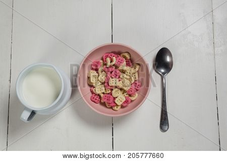 Overhead of honeycomb cereal and milk on wooden table