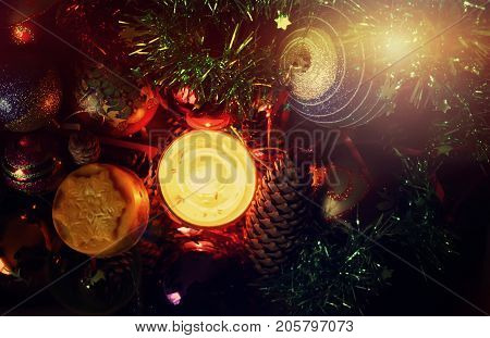 Burning Candle And Christmas Decorations In The Box.