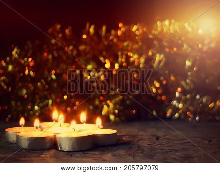 Burning Wax Candles On Christmas Decoration Background.