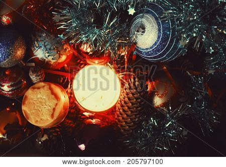 Burning Candle And Christmas Decorations In The Box.