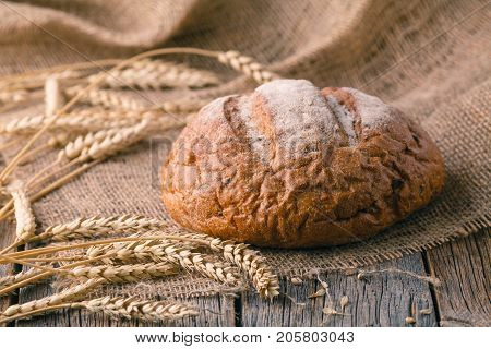 Homemade bread with seed on wooden table