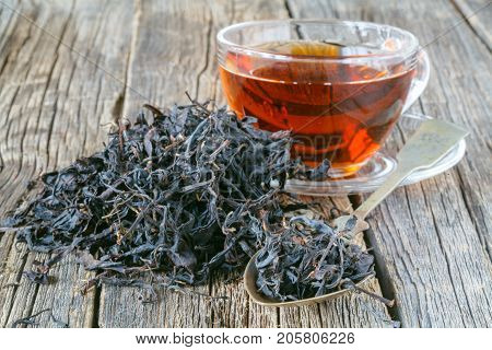 Dry Leaf Of Chenesse Tea And Glass Cup