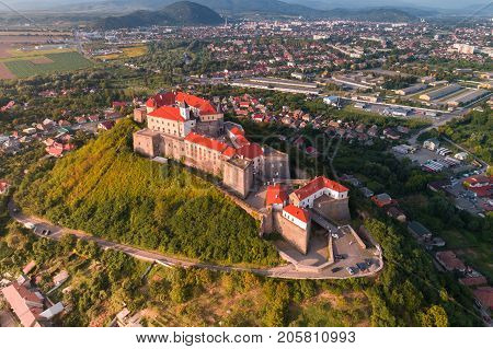 Aerial view of the Majestic Fortress - Palanok Castle towering above the city of Mukacheve, Ukraine.