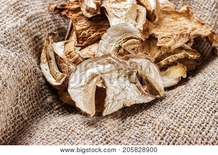 dried mushroom on sackcloth. Top view dried porcini mushrooms.