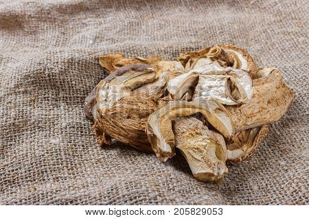 dried mushroom on sackcloth. Top view dried porcini mushrooms.
