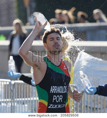 STOCKHOLM - AUG 26 2017: Running triathlete Miguel Arraiolos (POR) splashing water from a bottle in his face in the Men's ITU World Triathlon series event August 26 2017 in Stockholm Sweden