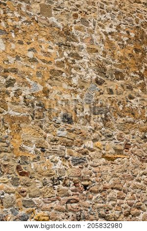 Ancient stone wall of a sea fortress. Masonry of old stones and bricks. Beautiful unusual background.