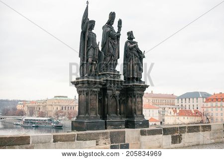 Sculptures of saints Norbert, Sigismund and Vaclav. One of the ancient statues on the Charles Bridge in Prague in the Czech Republic.
