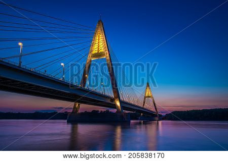 Budapest Hungary - The illuminated Megyeri Bridge over river Danube at blue hour with colorful clear sky
