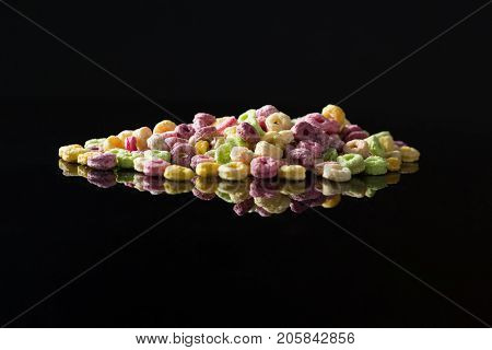 Close-up of froot loops on black background