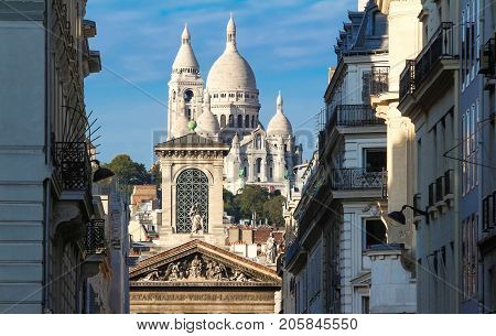 The basilica Sacre Coeur is a Roman catholic church located at the summet of the butte Montmartre , the highest point in Paris.