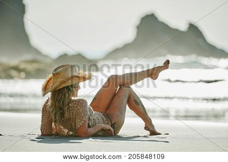 young woman relaxing on the beach in summer day