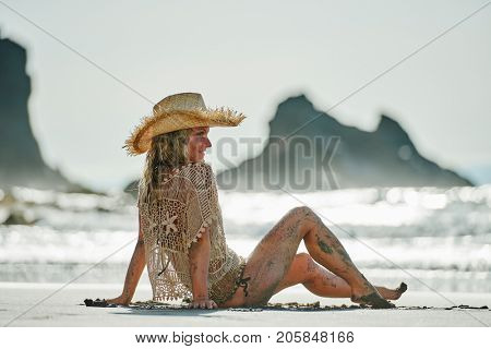 young woman relaxing on the beach in summer day