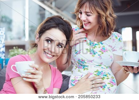 Two young women enjoying coffee time at home