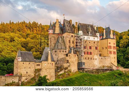 Burg Eltz castle in Rhineland-Palatinate state at sunset, Germany. Construction started	prior to 1157.