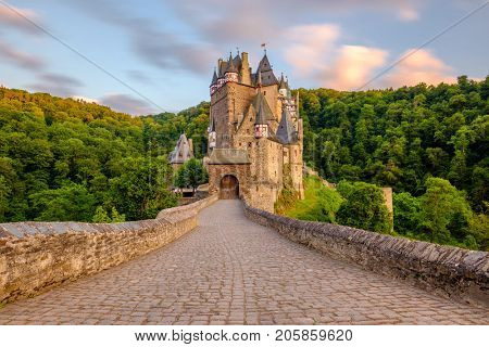 Burg Eltz castle in Rhineland-Palatinate state at sunset, Germany. Construction started	prior to 1157.