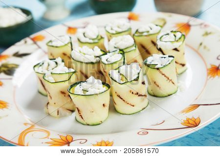 Grilled zucchini rolls filled with fresh cottage cheese