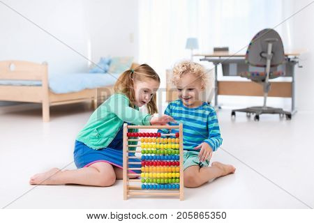 Kids Playing With Wooden Abacus. Educational Toy.