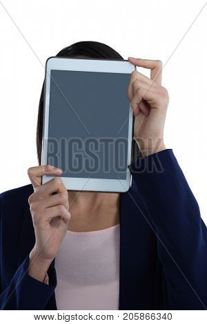 Businesswoman covering her face with digital tablet against white background