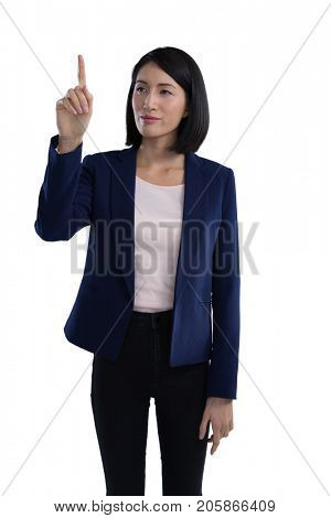Businesswoman touching invisible screen against white background