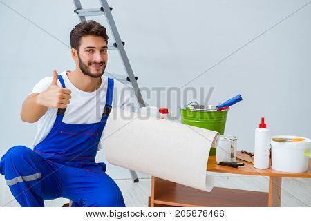Repairman doing renovation repair in the house with paper wallpa