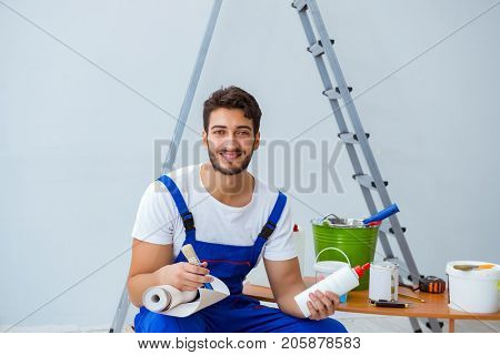 Repairman doing renovation repair in the house with paper wallpa