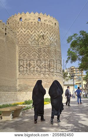 Fars Province Shiraz Iran - 19 april 2017: Two Iranian women in black Muslim clothes are walking near the Karim Khan citadel.
