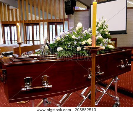 closeup shot of a colorful casket in a hearse or chapel before funeral or burial at cemetery