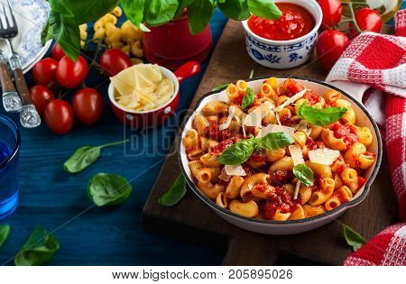 Pasta with spicy tomato sauce, parmesan and basil. Pasta Chifferi Rigati.