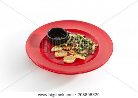 Teppanyaki Japanese and Korean Grill Food - Sea scallop with vegetables mushrooms on sauce on  red plate on white isolated background. Pan Asian menu
