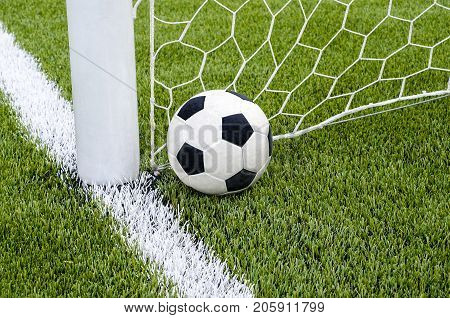 The Soccer Football With The Net On The Artificial Green Grass Soccer Field