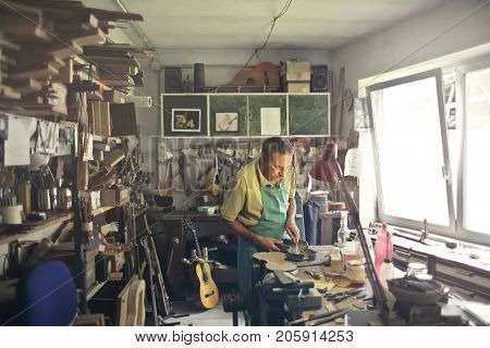 Lutist shaping a violin
