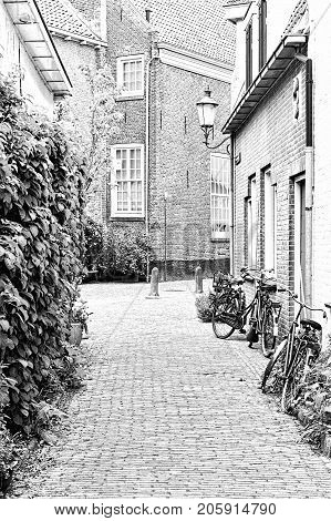 Typical Dutch brick houses in Holland. Street View with bikes parked in the historical center of Amersfoort in the Netherlands. Black and white picture