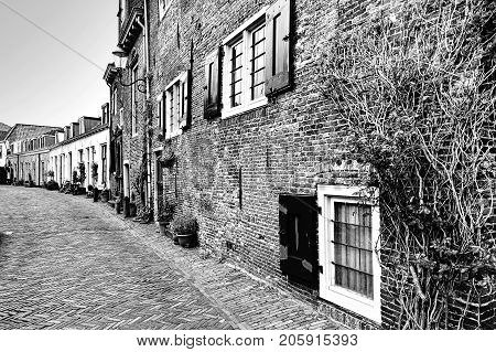 Typical Dutch brick houses in Holland. Street View with bikes parked in the historical center of Amersfoort in the Netherlands. Black and white picture