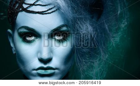 Closeup portrait of unworldly scary woman looking at camera.