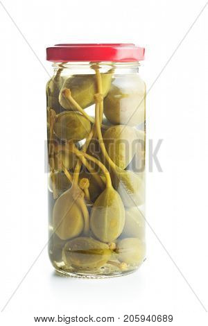 Pickled caper berries in jar isolated on white background.