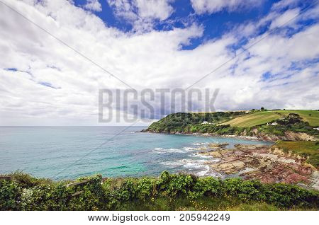 Beautiful view over the clear blue waters of Talland Bay on a sunny summer´s day in South Cornwall, England.