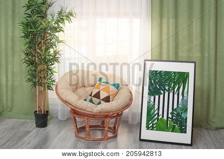 Modern room design with framed picture of tropical leaves and papasan chair
