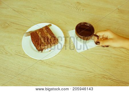 Coffee cup and chocolate cake onon wooden table. Coffee and a piece of cake - Retro color